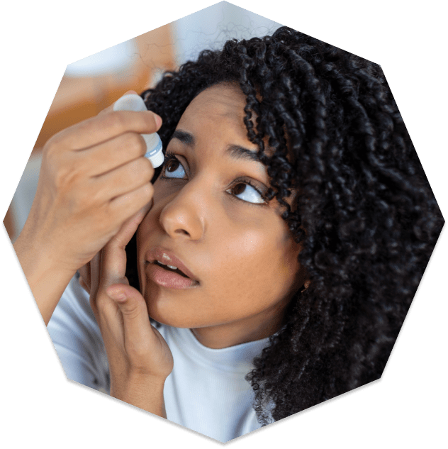 Woman putting in dry eye drops