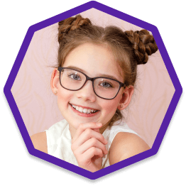 Child smiling wearing new eyeglasses