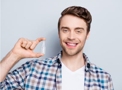 Man with artificial tears for dry eye relief at Insight Eyecare Man with artificial tears for dry eye relief at Insight Eyecare