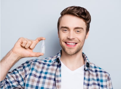 Man with artificial tears for dry eye relief at Insight Eyecare