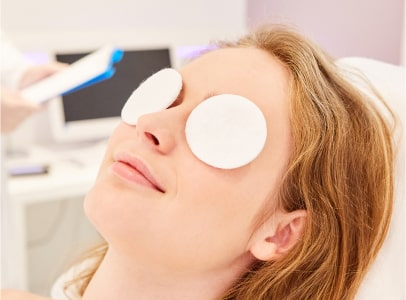 Woman getting moist eye compress at Insight for dry eye Woman getting moist eye compress at Insight for dry eye
