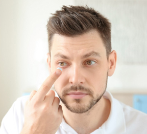 Man putting on contact lenses