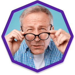 Man pulling down glasses and squinting